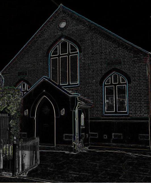 The Old Chapel at night, picked out in fine lines against a black sky